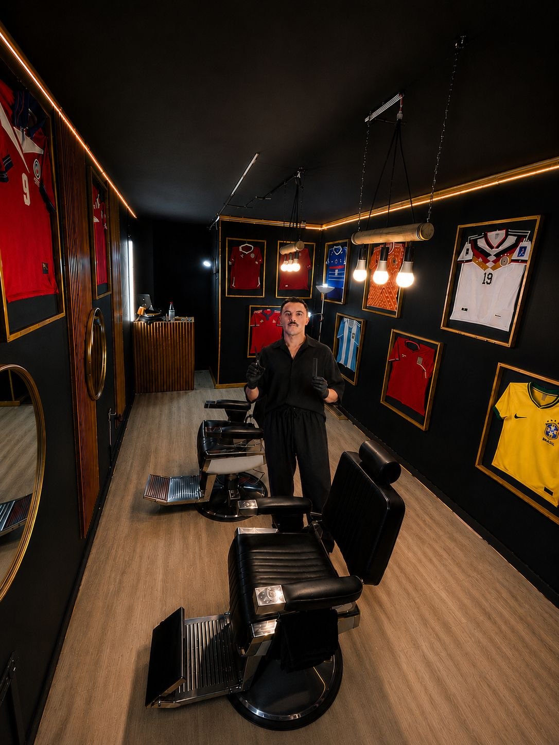 Interior de BBSCLUB con sillas de barbería y camisetas enmarcadas